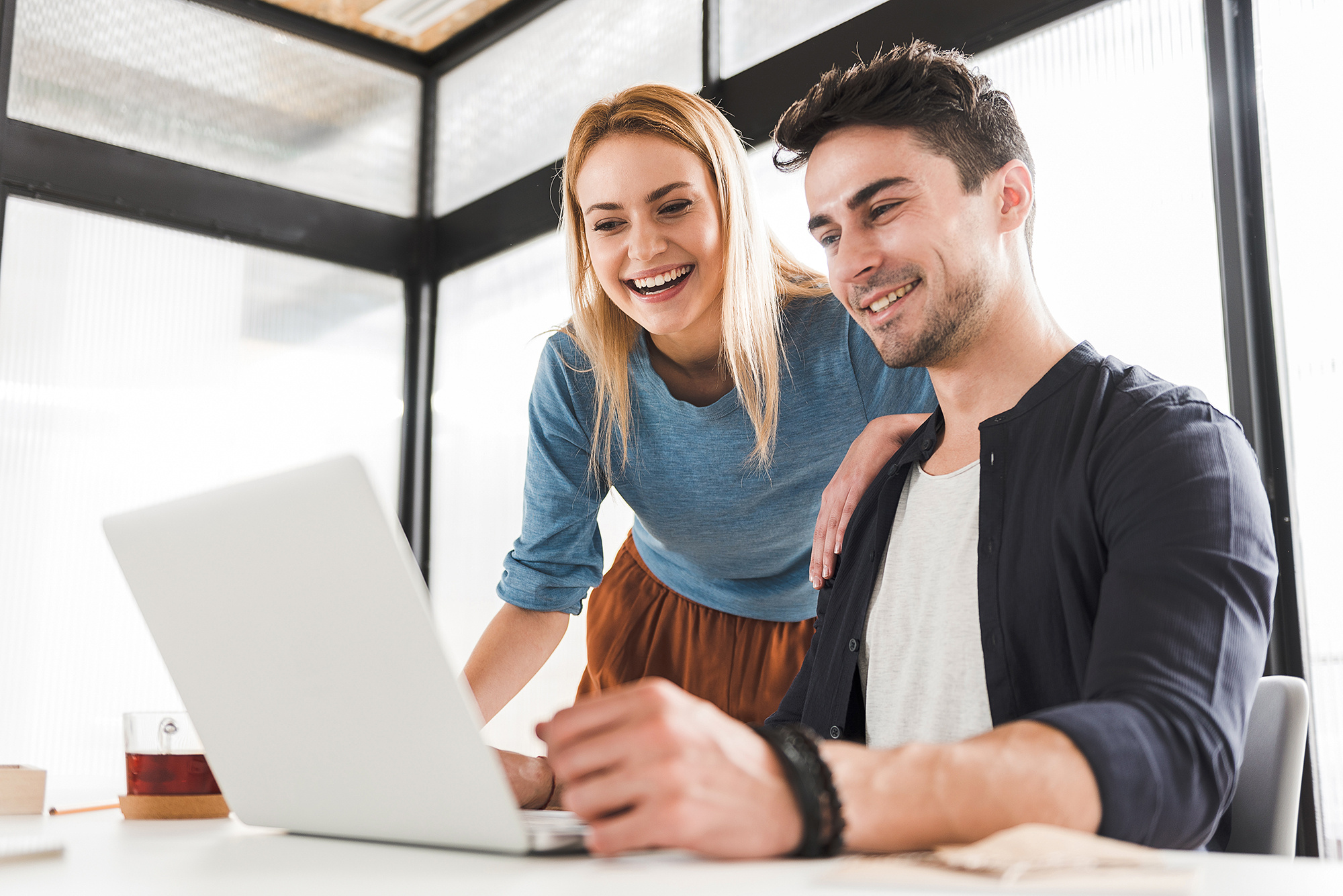 Smiling people sitting at computer